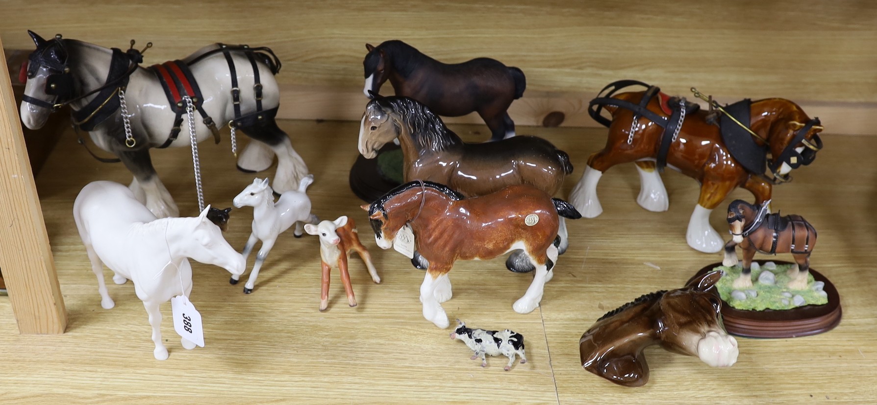 A collection of mixed Beswick, horses, to include cart horses a wall pocket, white glazed horse and a Border Fine Arts Clysdale Stallion